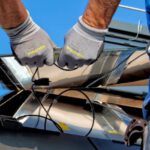 Solar Panels Comparison - two men carrying a metal sheet