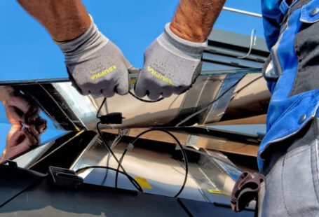 Solar Panels Comparison - two men carrying a metal sheet