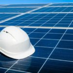 Solar Panels Paperwork - a white hard hat sitting on top of a solar panel