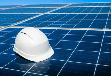 Solar Panels Paperwork - a white hard hat sitting on top of a solar panel