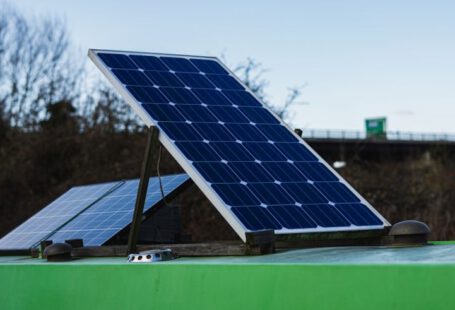 Solar Inverter Technology - blue and white solar panel on green metal bar during daytime