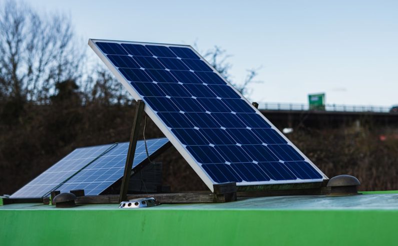 Solar Inverter Technology - blue and white solar panel on green metal bar during daytime