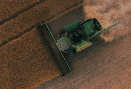 Solar Equipment Tech - green farming equipment on brown field