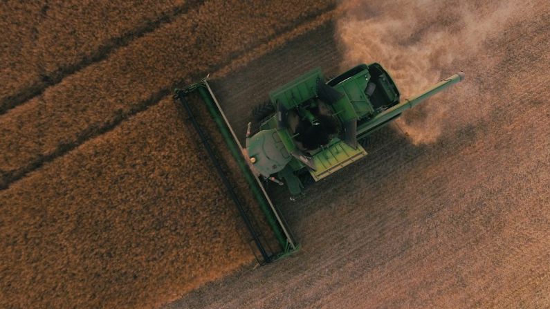 Solar Equipment Tech - green farming equipment on brown field