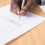 Warranty Document Solar - person writing on white paper