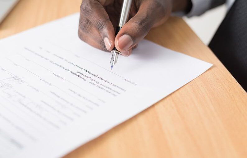 Warranty Document Solar - person writing on white paper