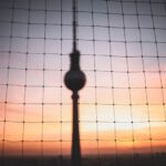 Net Metering Infographic - silhouette photo of hanging decor behind chain link fence at golden hour