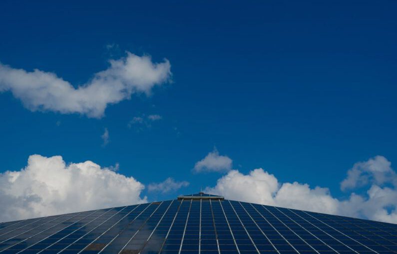 Solar Panel Close-up - a very tall building with a sky background